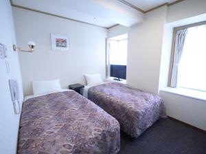 Postel nebo postele na pokoji v ubytování U-Community Hotel