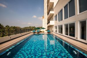 a swimming pool in the middle of a building at Fairway Sunset Serviced Apartments in Galle