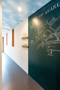 a chalkboard wall with a map of asia on a wall at plat hostel keikyu asakusa karin in Tokyo