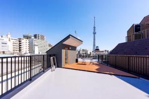 a rooftop deck with a view of the city at plat hostel keikyu asakusa karin in Tokyo +70 photos