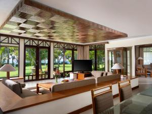 a living room with a couch and a tv at Holiday Resort Lombok in Senggigi 