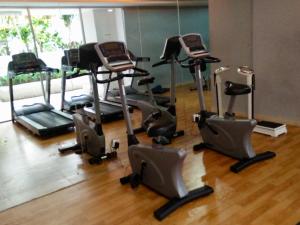 a gym with several exercise bikes in a room at Channel Stay @ Bassura City Apartment in Jakarta