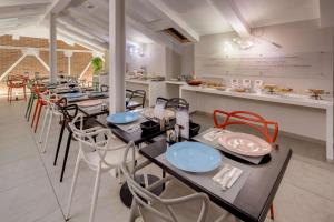 a kitchen filled with tables and chairs at Best Western Plus Royal Superga Hotel in Cuneo