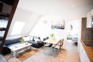 a living room with a couch and a table at Ferienwohnungen in Wremen in Wremen