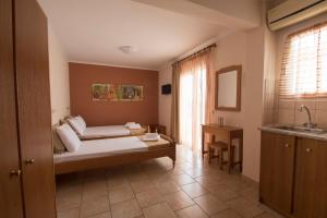 A bed or beds in a room at Atira Apartment Hotel