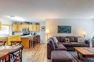 a living room with a couch and a kitchen at Big Horn 7 in Big Sky