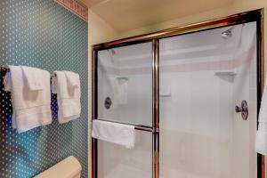 a bathroom with a shower with a glass door at Park 282 in Big Sky