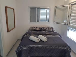 a bed in a room with two pillows on it at Studio avraham in Karmiel