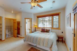 a bedroom with a bed and a ceiling fan at Antler Ridge in Big Sky