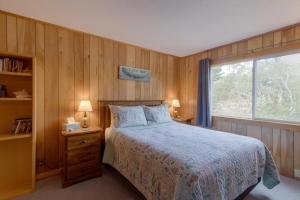 a bedroom with a large bed and a window at Rockaway Beach Surfer's Paradise in Rockaway Beach
