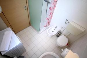 a bathroom with a toilet and a sink and a shower at CoZy Apartments in Timişoara +27 photos