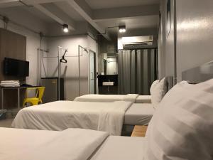a hospital room with two beds and a tv at S1hostel Bangkok in Bangkok