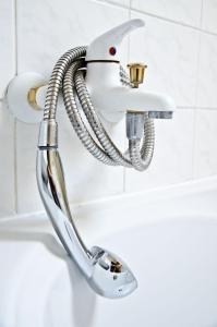 a shower head in a bathroom next to a sink at Penzión Evergreen in Trenčín