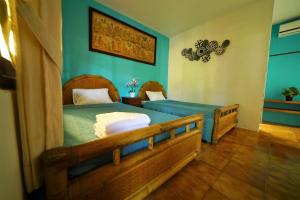 Кровать или кровати в номере Mangga Bungalow