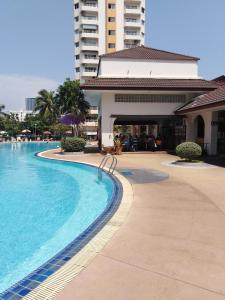 a swimming pool in front of a building at B&B View Talay 1B by Franco Jontiem in Pattaya South