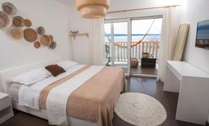a bedroom with a bed with a view of the ocean at Super Horizont beach house-FREE PARKING AND JACCUZZI in Split