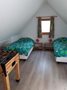 a room with two beds and a table in it at Chateau de Barbet 124 in Lombez