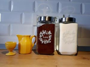 a counter with two bottles of sauce and some vases at D&C Studio in Bucharest +11 photos