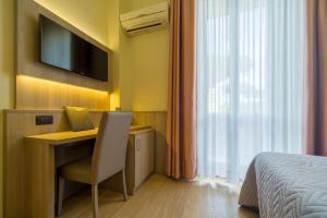 Postel nebo postele na pokoji v ubytování Hotel Est Piombino