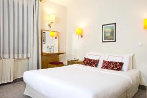 a hotel room with a large white bed with pillows at Ilkay Hotel in Istanbul