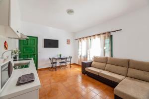 a living room with a couch and a table at Vacation Apartment Lanzarote VAL in Puerto del Carmen