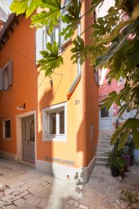 an orange building with stairs leading to a doorway at Noemi's rooms in Rovinj
