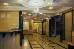a hallway in a building with a ceiling at Sleep Inn Hotel - City Centre in Dar es Salaam