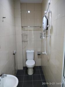 a bathroom with a shower and a toilet and a sink at Pz Hotel in Kuala Kangsar