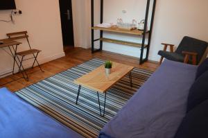 a living room with a table and a couch at Generaator Sofia in Sofia