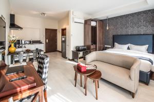 a hotel room with a bed and a living room at Glam Hotel Nairobi - Near Westgate Mall, Westlands in Nairobi