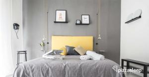 Posteľ alebo postele v izbe v ubytovaní PizzaSleep -apartment-