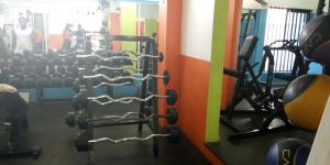 a gym with several rows of weights at Hôtels Résidences Easy in Cotonou