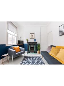 a living room with a couch and a fireplace at Bright & Beautiful Period Property - Pass the Keys in York