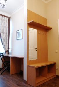 a small room with a wooden floor and wooden cabinets at Belokorichi in Kyiv