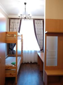 a bedroom with a bed and a desk at Belokorichi in Kyiv