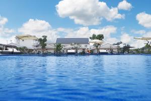 a large pool of water with buildings in the background at Nghi Son Hotel in Xóm Dữa
