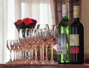 a group of wine glasses and a bottle of wine at Penzión Evergreen in Trenčín