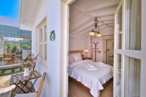 a bedroom with a bed and a balcony at Kose Konak Butik Hotel-Special in Alacati +124 photos