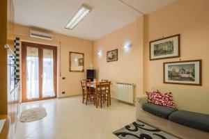 a living room with a couch and a table at Carla Suite Sorrento in Sorrento