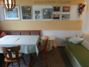 a dining room with a table and a couch at Haus Karwendelblick in Leutasch