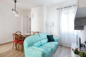 un soggiorno con divano blu e tavolo di Giardino della Fortezza Apartment a Firenze