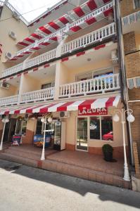 a store front of a building with red and white awnings at Laguna Plus in Utes