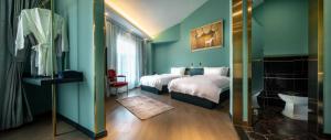 a hotel room with two beds and a bathroom at Moon and Chalice Boutique Hotel in Kunming