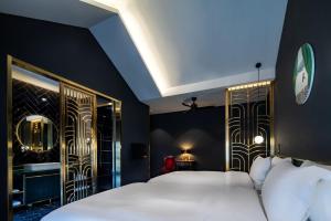 a bedroom with two white beds and a blue wall at Moon and Chalice Boutique Hotel in Kunming