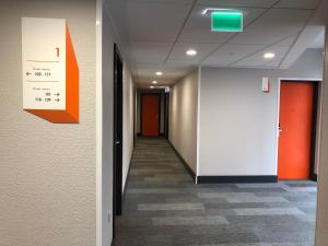 a hallway in an office building with a sign on the wall at easyHotel Birmingham in Birmingham +48 photos