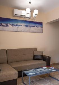 a living room with a couch and a glass table at Olympic Coast in Olympic Beach