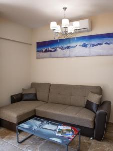 a living room with a couch and a glass table at Olympic Coast in Olympic Beach