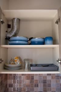 a pantry with plates and bowls on shelves at Olympic Coast in Olympic Beach