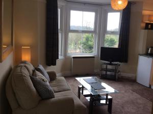 a living room with a couch and a coffee table at Parkview Apartments in High Wycombe