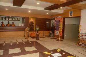 a lobby of a temple with people in the mirror at Hotel kanakabhishegam First Hotel From The Thirukadaiyur Temple in Tirukkadaiyūr